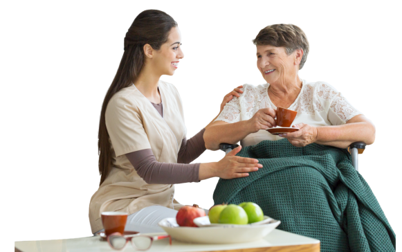 caregiver talking to the elder woman holding a cup of tea