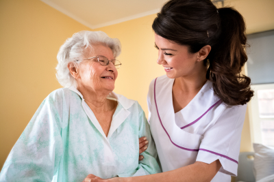 nurse helping the senior to walk