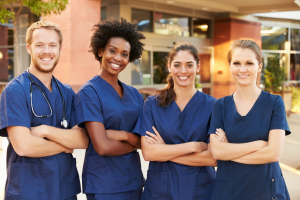 portrait of medical team standing outside hospital