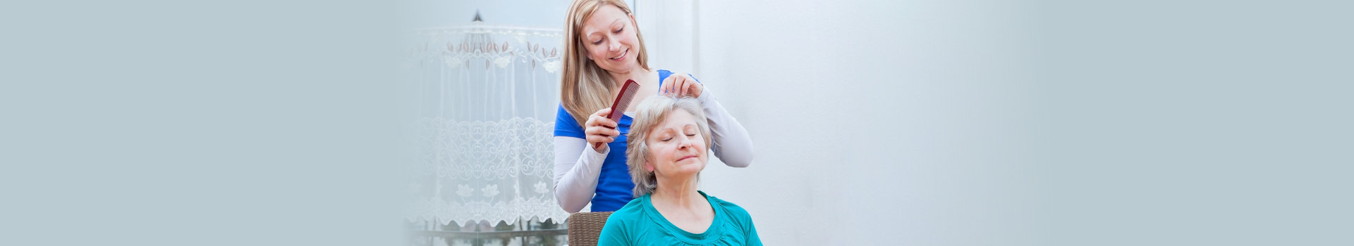 Blond young women combing seniors hair