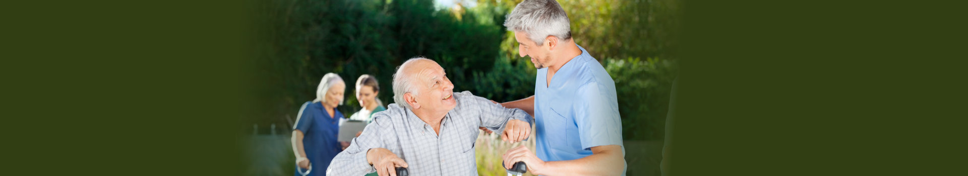 Male and female caretakers helping elderly people in nursing home