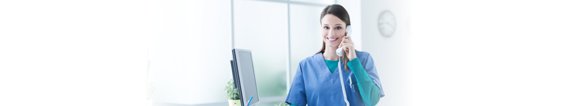 Young female doctor and practitioner working at the reception desk