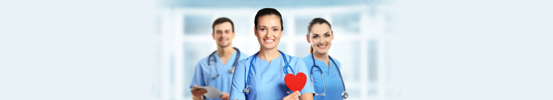 Young female doctor with red heart and medical team