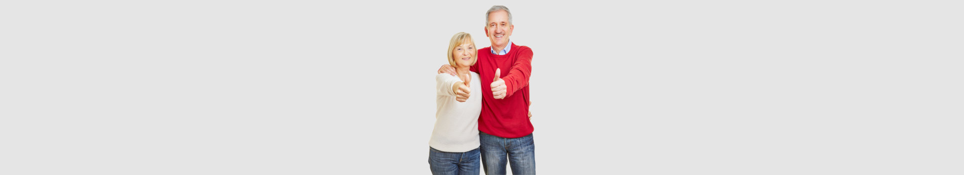 Happy senior couple holding thumbs up